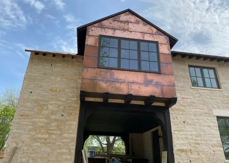 Copper metal panel facade on a stone building for Skylight Installation in Evansville
